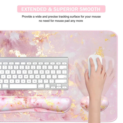 Top view of a 4 In 1 Large Gaming Mouse Pad For Gamers With Keyboard Wrist Rest And Mouse Wrist Support Extended Waterproof Desk Pad For Home Office Study And Gaming Pink Gold Marble Finish, showing keyboard and hand holding mouse.