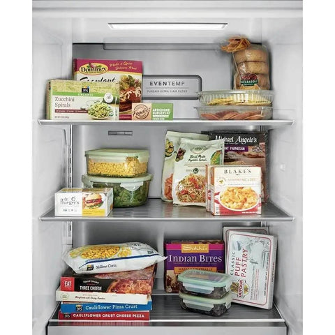 Various frozen meals and vegetables stored in a refrigerator, including boxed pizzas, pasta, and veggie dishes.
