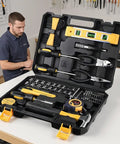 Comprehensive 78 Piece All In One Hand Tool Set for Home Auto and Office with Portable Storage Case Built For DIY Projects and Basic Repairs Includes Level Hammer Pliers Wrenches Screwdrivers Sockets and More in black case open on table.