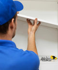 Person adjusting a shelf using Heavy Duty Metal Shelf Clips With Super Sturdy Adjustable Mounts For Closets And Bookshelves.