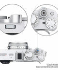 Deluxe Metal Thumb Up Grip for Fuji X100V camera mounted on hot shoe, showing secure hold and non-interfering controls