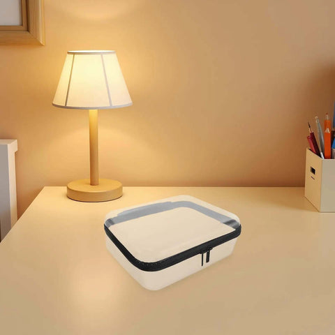 Built Different Clear Hard Shell Zipper Case For Travel Toiletries And Makeup Organizer on a desk with a lamp