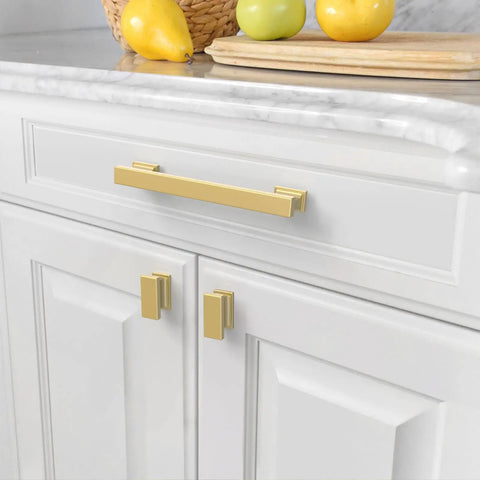 Kitchen cabinet with 10 Pack Brushed Gold Cabinet Knobs Set, 1.46-Inch Rectangle Single Hole Drawer Pulls for Cabinets, Dressers, and Bathroom Vanities, Sturdy Metal Knobs for Easy Install and a Slick Modern Look, on white cabinets and marble counter.