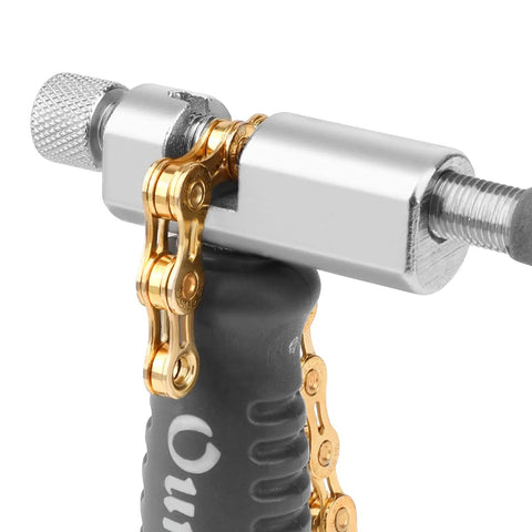 Close-up of Bike Chain Breaker Tool Universal For 7 To 11 Speed Chains Chain Splitter in use, showing metal and plastic parts.