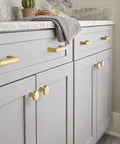 Champagne Bronze Cabinet Knob for Drawers and Cabinets, 1-5/16 Inch Diameter (33mm) on light gray cabinetry in a bathroom setting