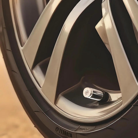 Close-up of a wheel with 40 Cal Bullet Shaped Tire Valve Stem Caps Set Of 4 For Cars SUVs Trucks Motorcycles BMX Bikes And Bicycles Nickel Finish