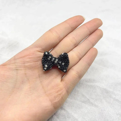 60Pc Glossy Black Disco Ball Beads With Sparkly Rhinestone on hand, showcasing shimmering bow design for DIY crafting.