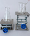 Front view of two stainless steel lab jack stands with table lift, 4x4 top plates, blue knobs; beakers on platforms