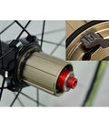 Close-up of the hub and cassette area of a 700C Road Wheelset With 30mm Aluminum Double Wall Rims, showcasing quick release mechanism.