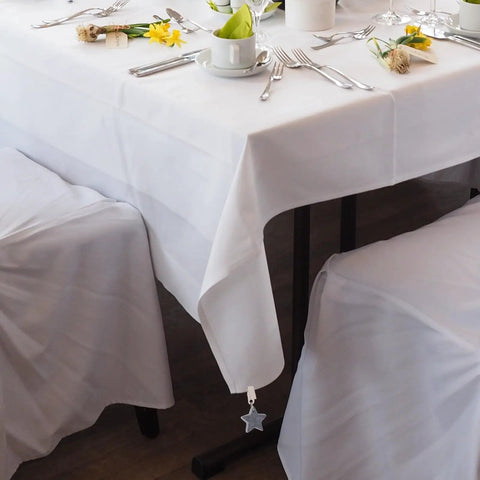 Table with Eight Ounce Tablecloth Weights With Stainless Steel Clips For Outdoor Tables Stay Put Windproof Patio And Picnic Setup Rust Resistant Stone Weights To Keep Cloth Flat In Gusty Weather Gray, featuring gray star-shaped clip on white tablecloth.