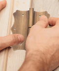 Heavy Duty Copper Door And Window Hinges Built Tough With Vintage Retro Style And Ornate Decorative Edges For Smooth Operation And Stable Performance On Kitchen Doors And Construction Projects Great For Home Renovations And Custom Builds being installed