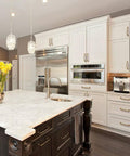 Modern kitchen with white cabinets featuring Six Pack 5 Inch Antique Brass Cabinet Handles With Linear Coin Edge Texture for renovation.