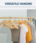 Straight Up Premium Quality Natural Wooden Coat Hangers Thirty Pack flat profile wood suit hangers with clothes displayed on a rack.