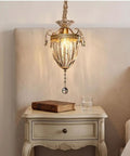 vhhob French Light Luxury Crystal Pendant Lamp Ceiling Hanging Fixture illuminating a cozy bedside table with a book and glass.