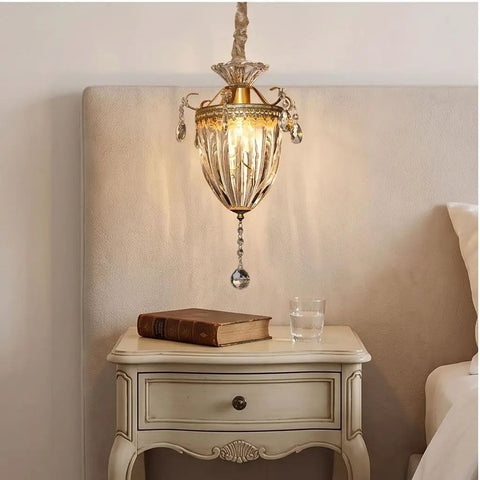 vhhob French Light Luxury Crystal Pendant Lamp Ceiling Hanging Fixture illuminating a cozy bedside table with a book and glass.