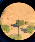View through Springer Air Rifle Scope 3 To 9X40 AO With Illuminated Mil Dot Reticle showing landscape with trees.