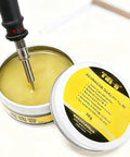 Pro Grade Lead-Free Rosin Solder Flux Paste No Clean For PCB Chips Motherboards Electronics, open tin with soldering tool inside.