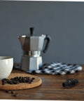 Steam Wand Rubber Guard Sleeve Heat Insulation Accessory For Espresso Machines next to espresso maker on wooden table.