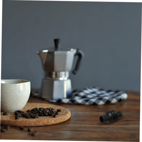 Steam Wand Rubber Guard Sleeve Heat Insulation Accessory For Espresso Machines next to espresso maker on wooden table.