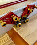 Pro Grade Portable Aluminum Table Saw Roller Feeder Dolly Featuring Smooth Ball Bearings, close-up of roller assist with wood.