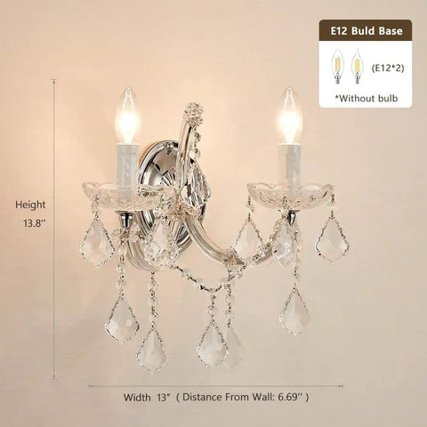 Snag These Cool Crystal Wall Sconces Boasting A Maria Theresa Design With Two Brilliant Lights Ideal Wall Mounted Fixtures For Your Bedroom Living Room Bedside Or Corridor, 13W x 13.8H, chrome finish, crystal accents, lit view