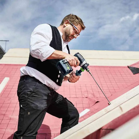 Heavy Duty Brushless Cordless Drill And Driver With Unbreakable Gears And 18 Volt Battery in use on a construction site.