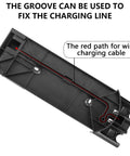 Front view of black plastic docking wall mount for Dyson V7/V8 cordless vacuum, showing charging cable channel.