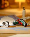 Hecka Heavy Duty Power Drill Cutting Adapter Slick Six Millimeter Blade with Bosch cordless driver on cardboard for trimming.