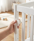 Hand adjusting Heavy Duty Adjustable Bed Rail Guard Hardware with smooth lifting tracks on white crib