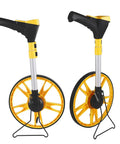 Two angles of the ULTRAK M180 Digital Measuring Wheel - Feet/Meters, Backlit Display & Memory with adjustable handle and bright yellow wheels.