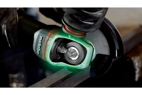 Beefy Four And A Half To Five Inch Angle Grinder with Eleven Thousand RPM and Twelve Amp Power AC DC Versatility in action on metal