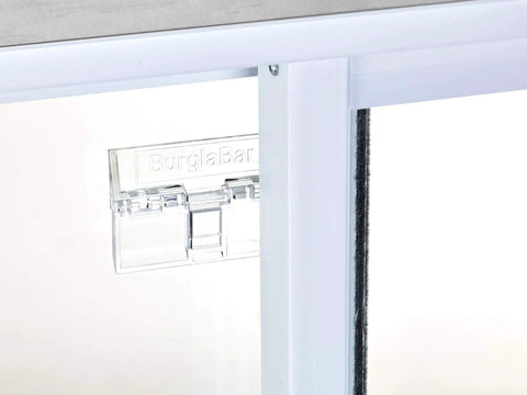 Close-up of a clear sliding door security bar hinge style lock for patio doors, easy to install and childproof, enhancing home security.