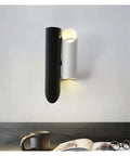 Rock Solid Black Iron Wall Sconce With Pivot Led Fixture And Chill Warm Glow Modern Minimalist Bedside Lighting Zero Glare Low Maintenance Quick Setup on a light gray wall.