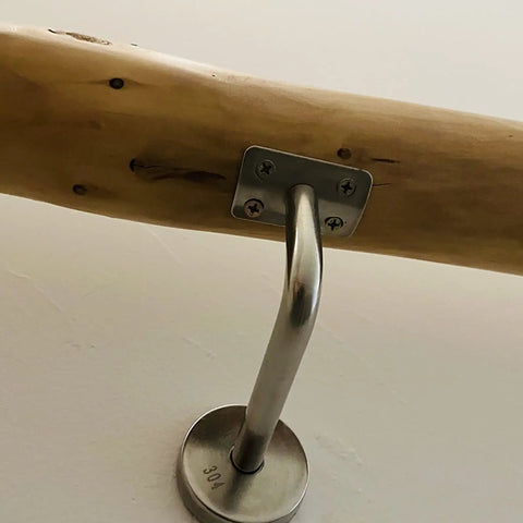 Close-up of Natural Solid Wood Stair Handrail Eight Foot Non Slip Railing with metal mounting bracket.