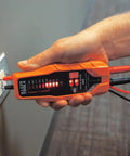 Hand using ET60 Voltage Tester For AC And DC Voltage No Batteries Needed Wide 12 To 600 Volt Range Quick Checks With Standard Test Leads