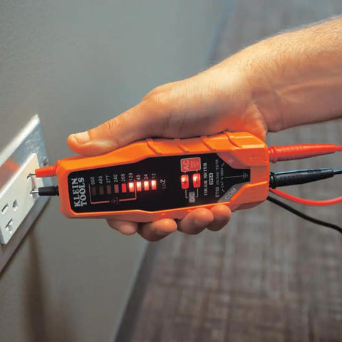 Hand using ET60 Voltage Tester For AC And DC Voltage No Batteries Needed Wide 12 To 600 Volt Range Quick Checks With Standard Test Leads