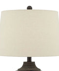 Textured Dot Jug Table Lamp With Dark Brown Finish Cast Resin Construction Oatmeal Linen Round Drum Shade close-up view