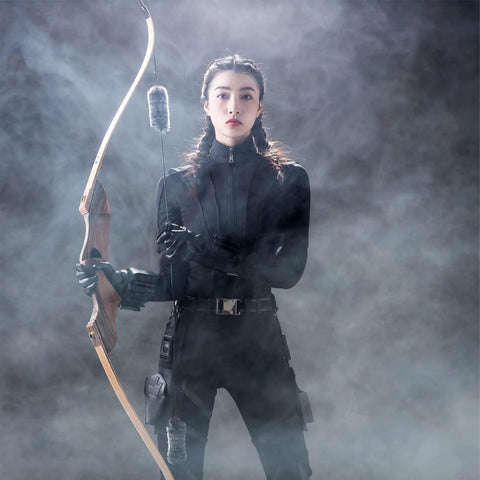 Archer holding a bow with Bow String Silencers For Recurve And Longbow One Pair Quiet Archery Accessory to Cut String Noise.
