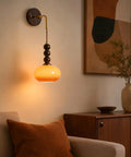 Flyrose Set of 2 Vintage Caramel Glass Wall Sconces Mid Century Modern Lamp with wooden accents in cozy living room setting.