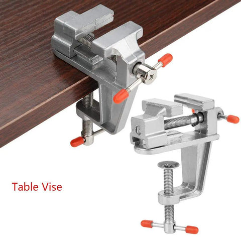 Rock Solid Mini Flat Pliers Bench Vise And Tabletop Clamp For Precision Woodwork Drill Press Vice Slick Aluminum Alloy Tool on a wooden surface.
