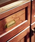 Six Pack 3 Inch Antique Brass Cabinet Cup Pulls With Hand Hammered Texture And Smooth Curved Edges on wooden kitchen drawer