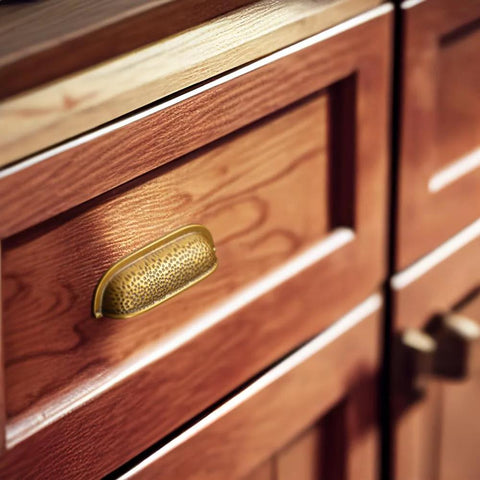 Six Pack 3 Inch Antique Brass Cabinet Cup Pulls With Hand Hammered Texture And Smooth Curved Edges on wooden kitchen drawer