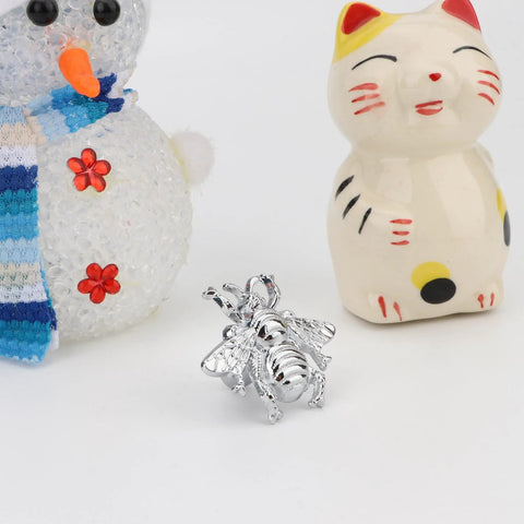 Bee Shape Brass Drawer Knob in silver finish displayed with snowman and cat figurines.