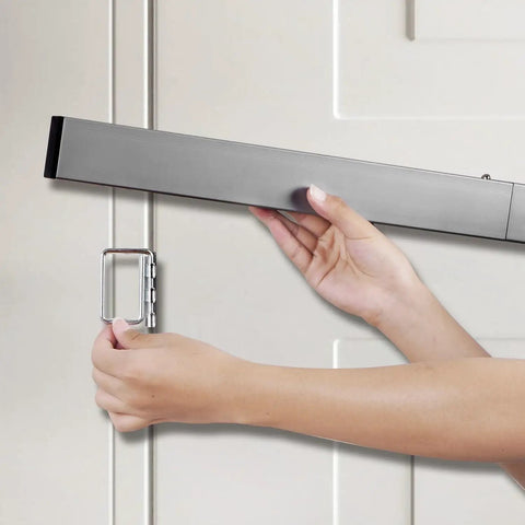 Person installing Heavy Duty Door Security Bar With Brackets Kit For Front Door, Easy Four Screw Install, shown in use.