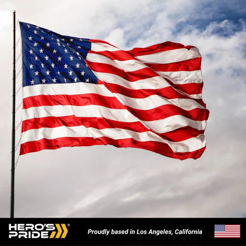 Waving American flag on flagpole against cloudy sky background with "Hero's Pride" logo at the bottom.