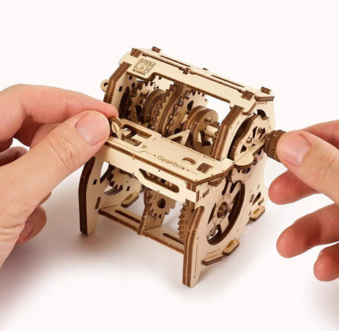 Gearbox Wooden Model Kit For Adults Teens And Kids Hands On DIY Mechanical STEM 3D Puzzle With App Learning Transmission Gears And Torque Realistic Moving Parts Durable Wood Construction Great Gift For Makers, wooden gearbox being turned by hands