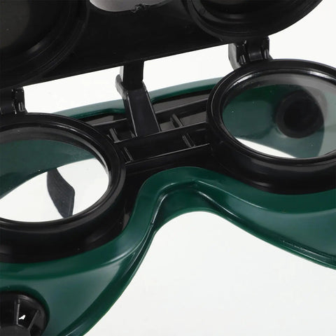 Kickass Dual Flip Up Welding Goggles Built Tough As Nails With Impact Resistance Square Vents For Heavy Duty Industrial Eye Protection Dustproof Shield Two Pack Safety Specs close-up view showing dual flip mechanism and green filter lens.