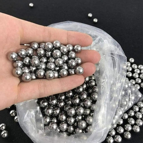 Heavy Duty G10 Steel Bearing Balls In 6.35mm Or 1 4 Inch Diameter held in hand, showing smooth shiny surface and bulk package.
