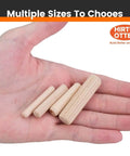 Hand holding 50 Piece Hardwood Dowel Pins 1/2 Inch By 2 Inch Kiln Dried Schima Superba Fluted And Beveled for woodworking projects