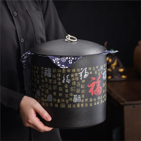 Heavy Duty Ceramic Food Storage Jar With Airtight Silicone Lid Keeps Your Pantry Looking Fresh And Organized Perfect For Bulk Tea Coffee Beans Spices Sugar And Cookies Retro Kitchen Container in hand, dark design with decorative lid.